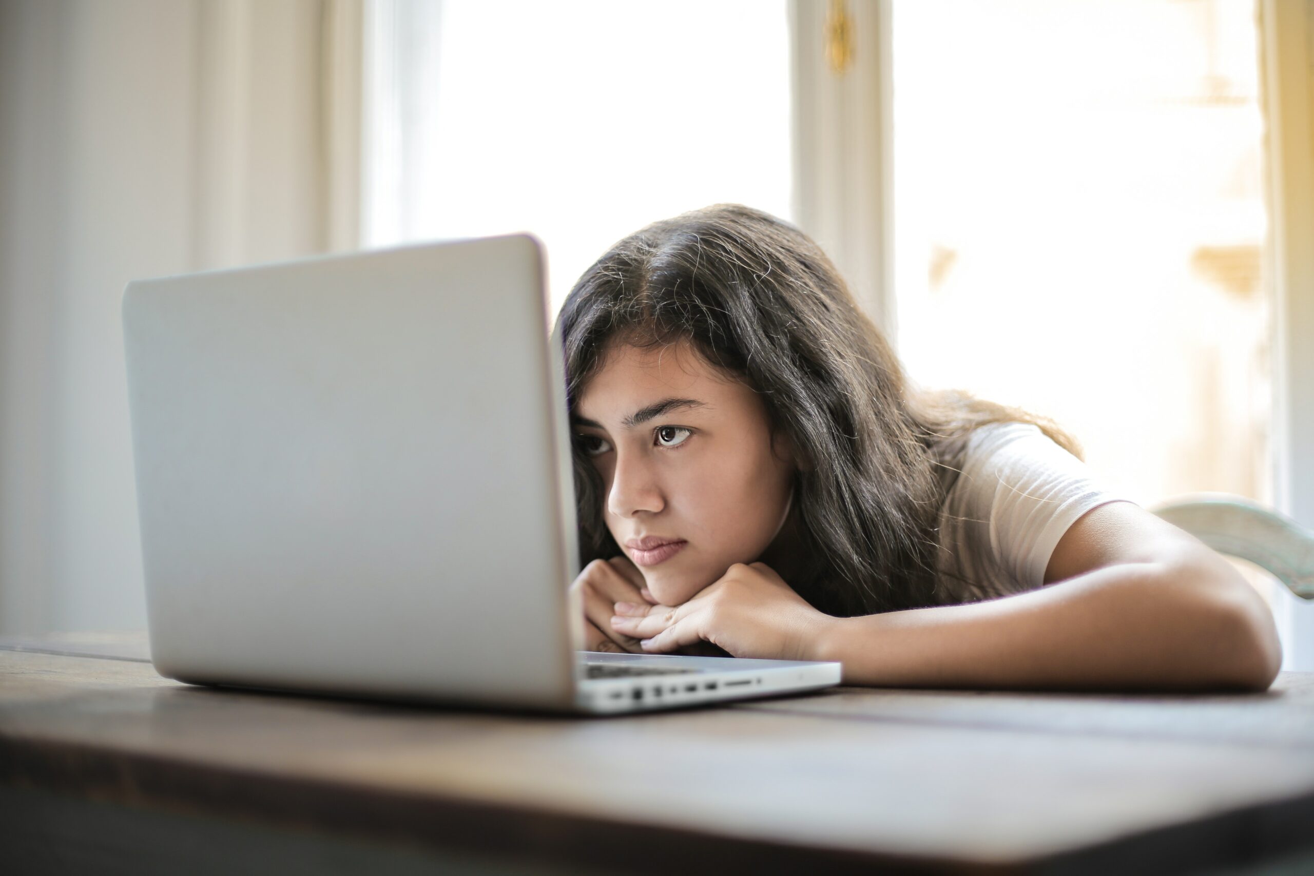 young-girl-resting-head-in-laptop